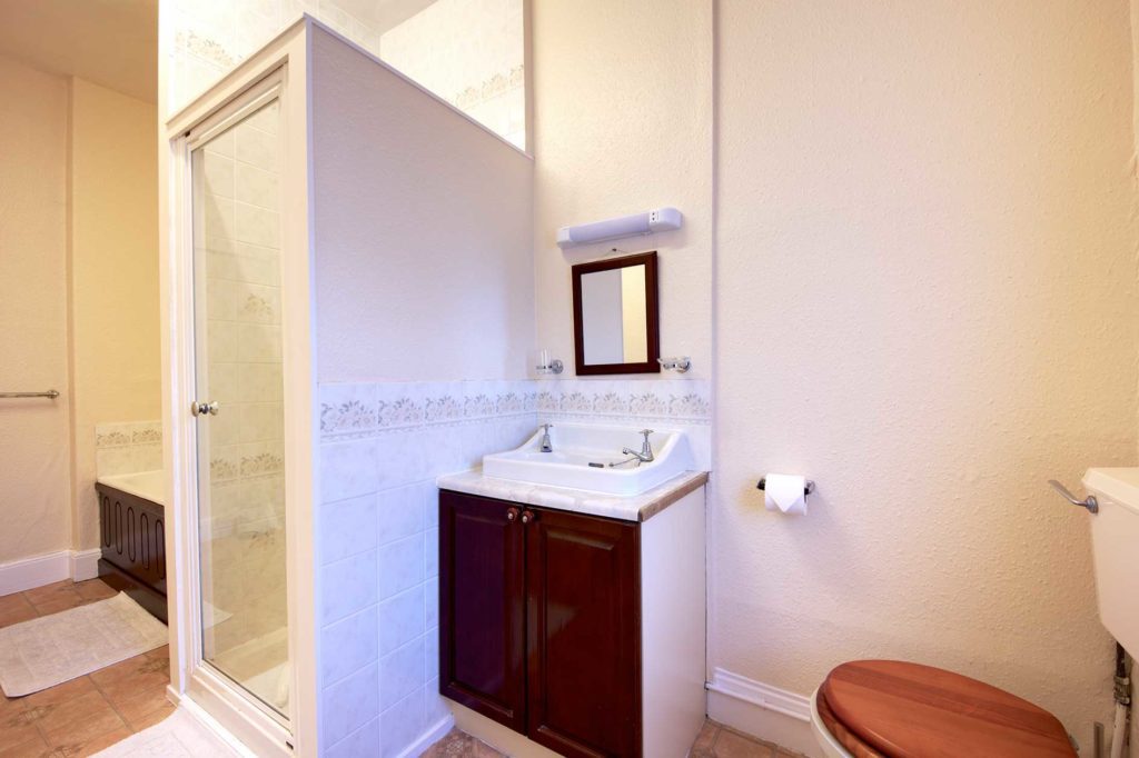 Bathroom with shower cubicle, bath, sink and toilet
